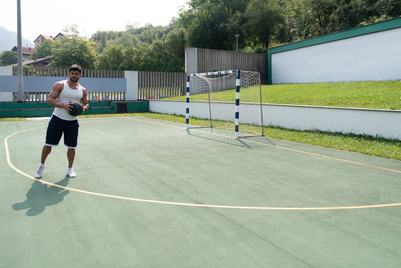 Basketball Player Shooting In A Playground stock photo
