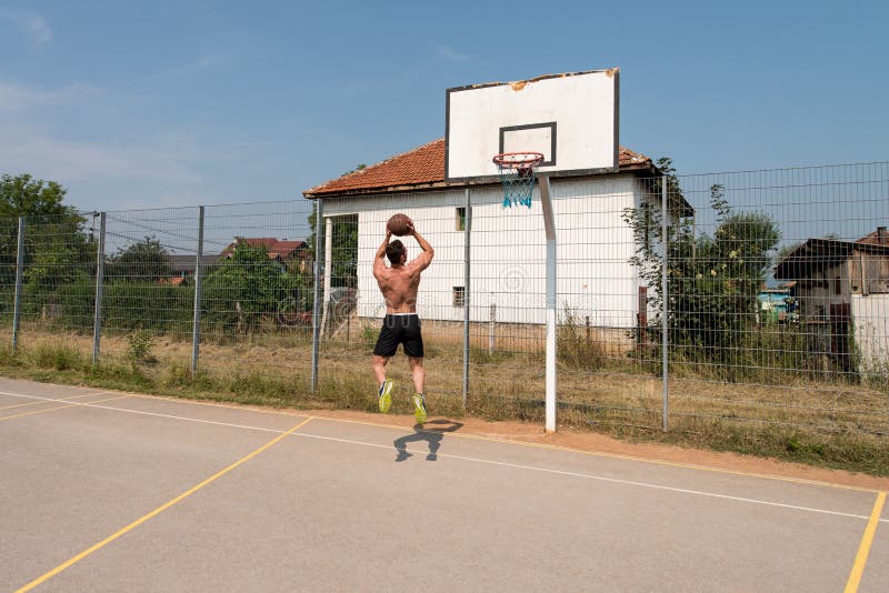 Basketball Player Shooting In A Playground royalty free stock photography
