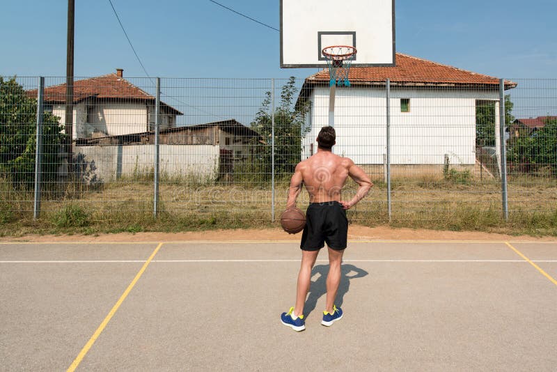 Basketball Player Shooting In A Playground stock photography