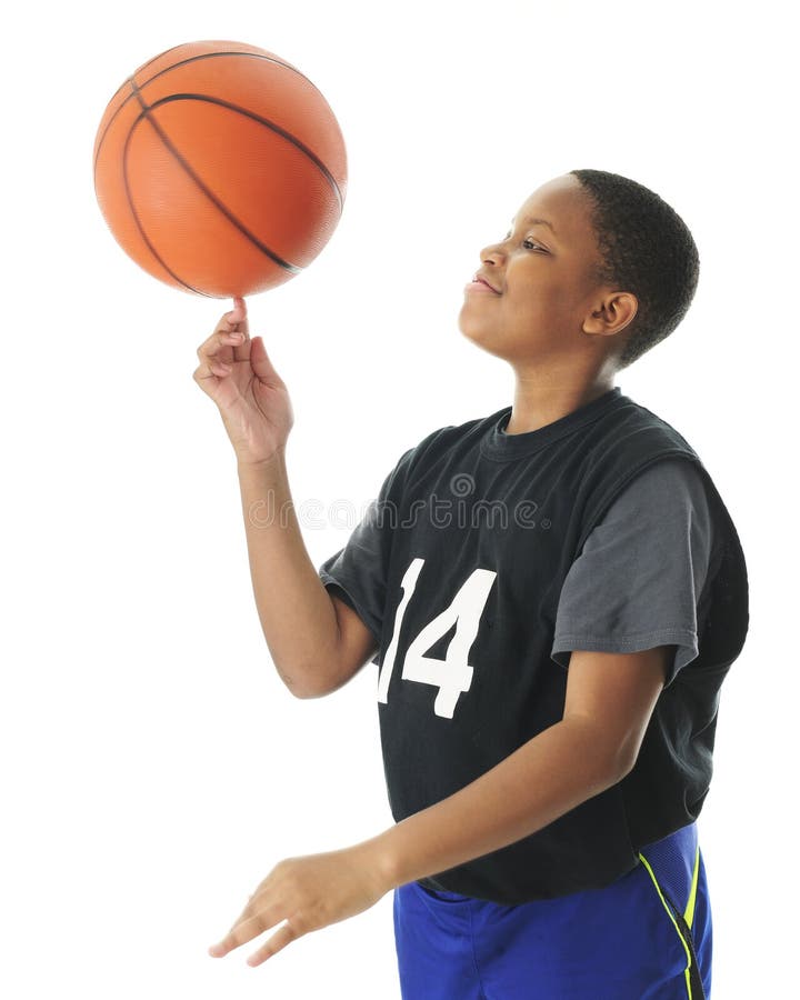 A preteen boy happily spinning his basketball on his index finger. Motion blur on the ball, On a white background. A preteen boy happily spinning his basketball on his index finger. Motion blur on the ball, On a white background.