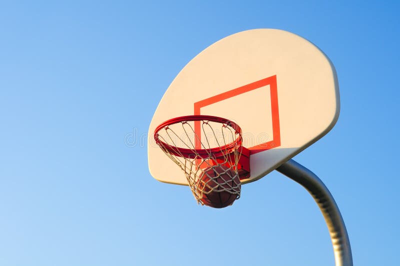 Basketball swooshes through a basketball hoop during a basketball