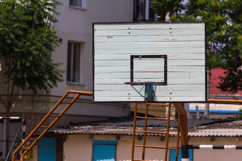 Basketball Wooden Backboard with a Ring on an Indoor Yard Stock Photo