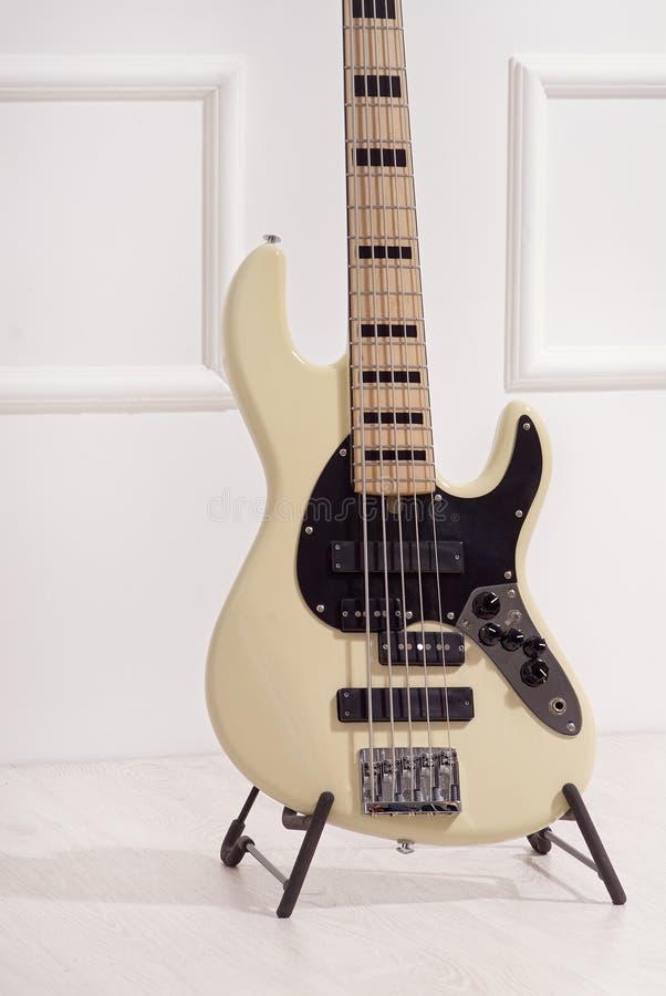 Bass Guitar Stands Near White Wall Stock Photos Free & RoyaltyFree
