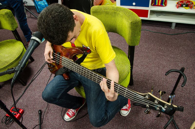 Bass Guitarist Sitting Playing His Instrument Stock Image Image of