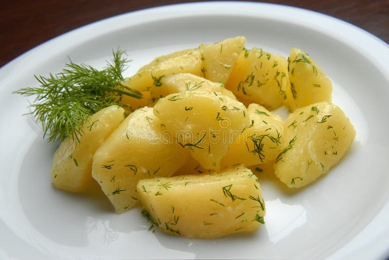 Boiled potatoes with butter and dill on a plate. Boiled potatoes with butter and dill on a plate