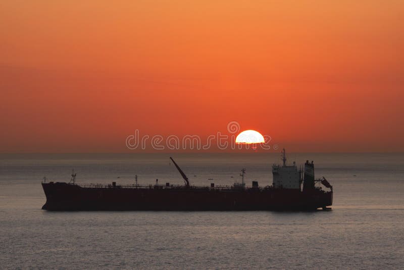 Cargo freight rig ship silhouette at sunset with sun on horizon. Logistics concept I use an ultra high quality CANON L SERIES lens to provide you the buyer with the highest quality of images. Please buy with confidence :-). Cargo freight rig ship silhouette at sunset with sun on horizon. Logistics concept I use an ultra high quality CANON L SERIES lens to provide you the buyer with the highest quality of images. Please buy with confidence :-)