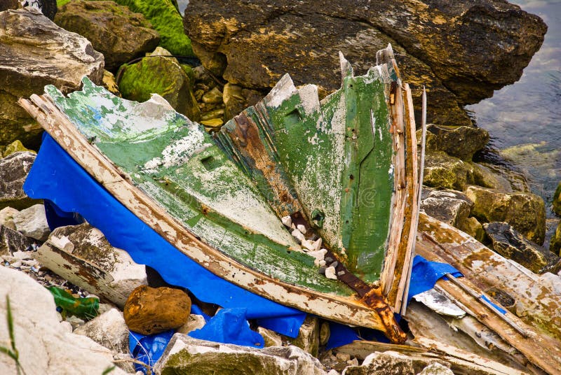 Broken boat on the rocks of Varna. Bulgaria. Shows danger and desolation. Broken boat on the rocks of Varna. Bulgaria. Shows danger and desolation.