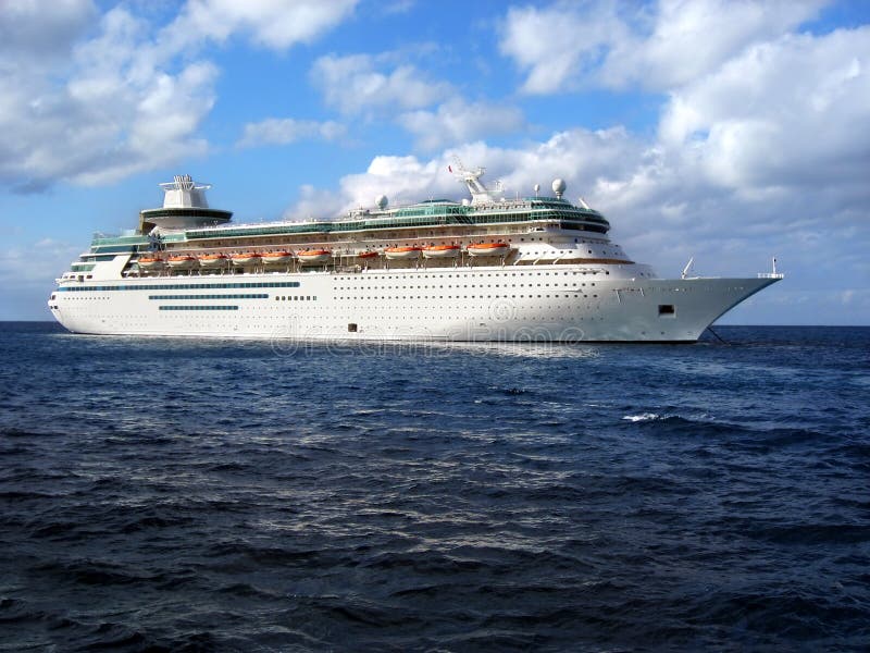 A cruise ship anchored in the middle of the ocean. A cruise ship anchored in the middle of the ocean