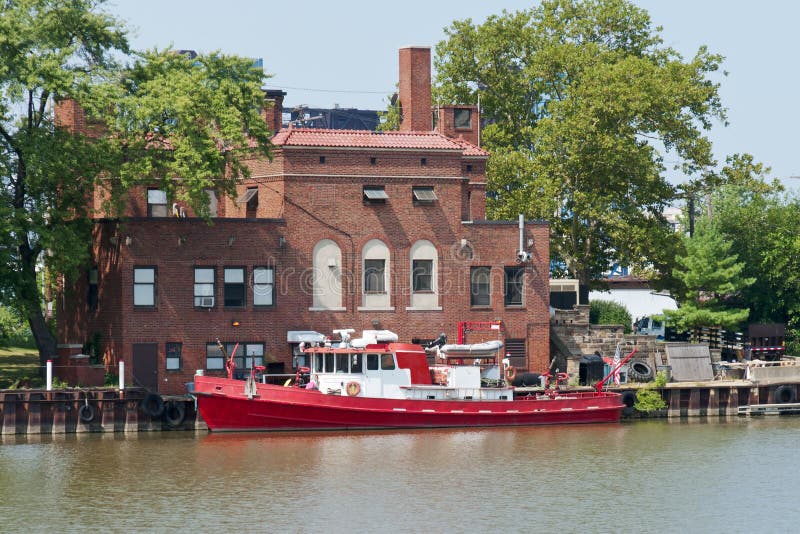 A fire boat used to protect the waterfront along the Cuyahoga River and the port of Cleveland, Ohio sits moored next to a riverfront fire station. A fire boat used to protect the waterfront along the Cuyahoga River and the port of Cleveland, Ohio sits moored next to a riverfront fire station