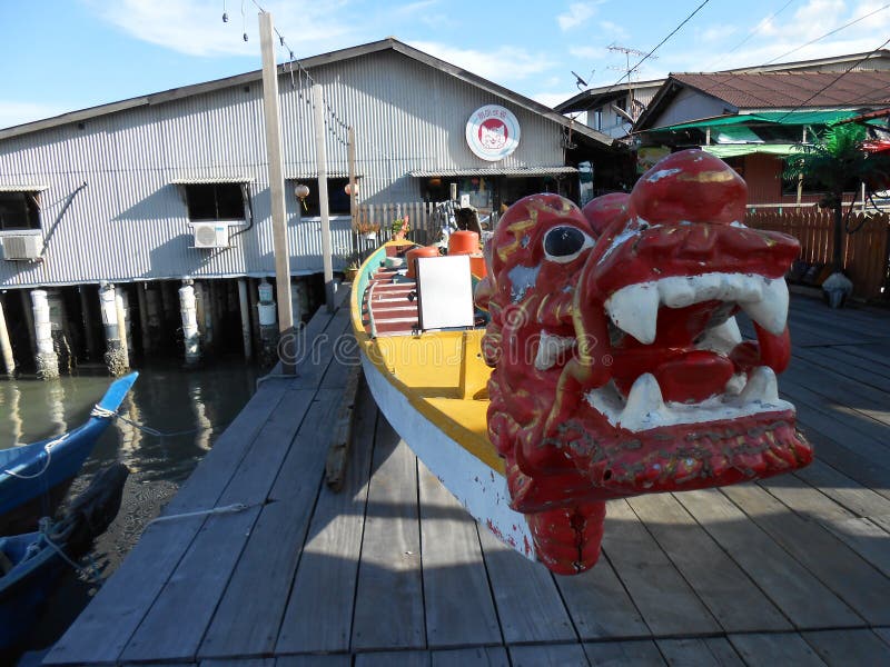 Georgetown, Penang, Malaysia, November 13, 2017: Dragon-headed boat at Chew Jetty, the floating town of Georgetown, Malaysia. Georgetown, Penang, Malaysia, November 13, 2017: Dragon-headed boat at Chew Jetty, the floating town of Georgetown, Malaysia