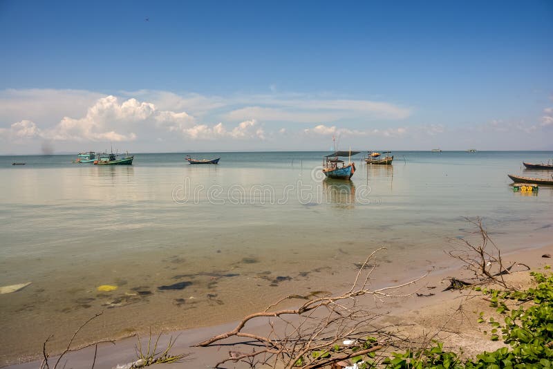 Bateaux de pêche vietnamiens dans Azure Sea calme par la plage photographie stock libre de droits Bateaux de pêche vietnamiens dans Azure Sea calme par la plage photographie stock libre de droits