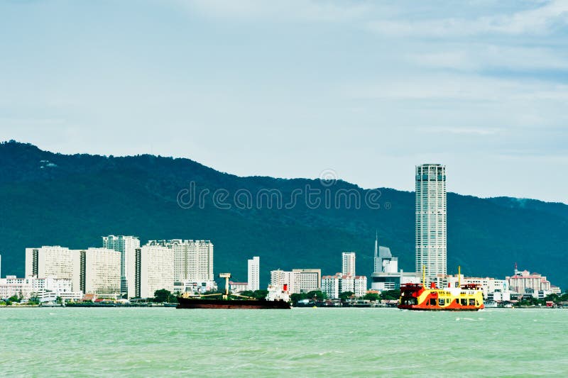 View of a boats on Penang straits with Georgetown area as the background. View of a boats on Penang straits with Georgetown area as the background