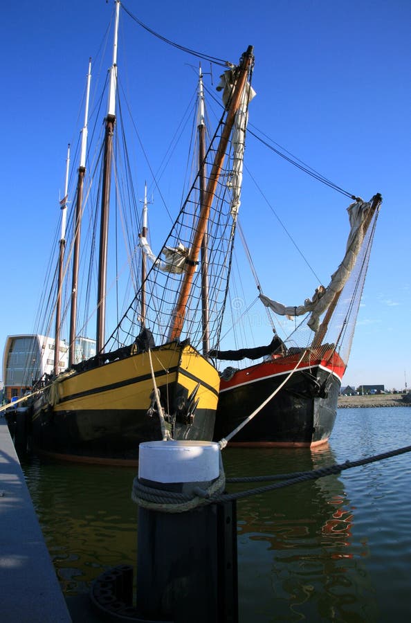 Two flat-bottomed Dutch boats moored in the port in Lelystad. Two flat-bottomed Dutch boats moored in the port in Lelystad