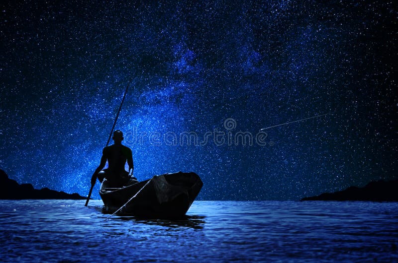 African boatman with his canoe on the river in front of the stars. African boatman with his canoe on the river in front of the stars