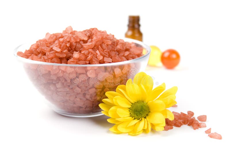 Bath salt, oil balls in a bowl and flower