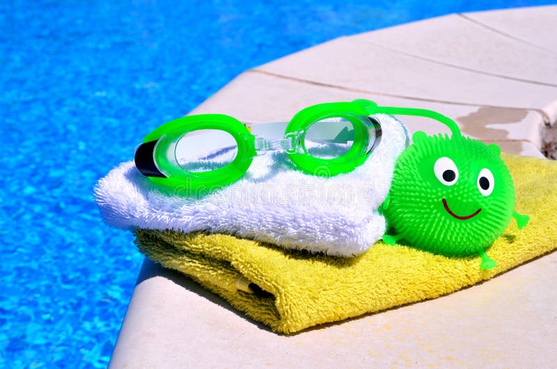 Bath towels, goggles, toy agains blue wate