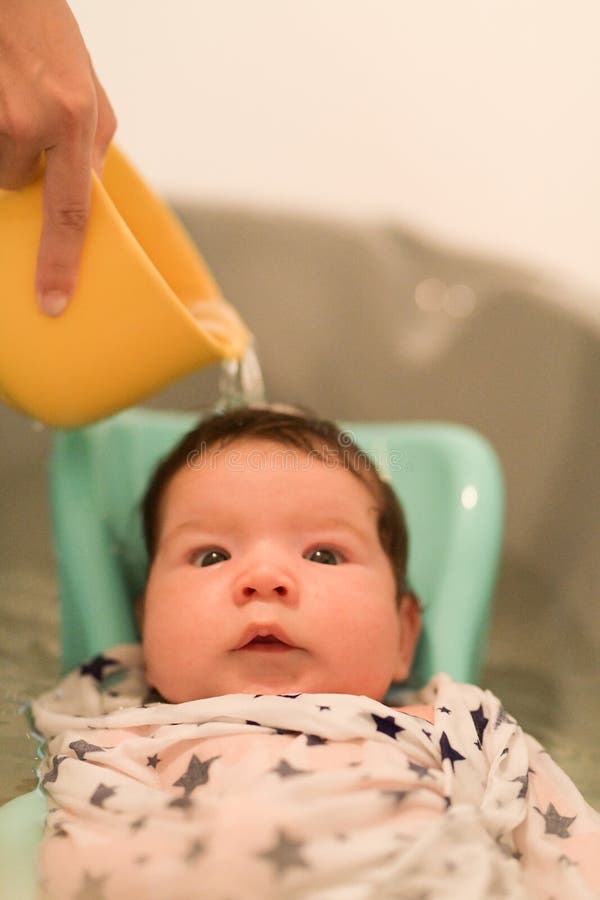 Bathing a Baby. Bathes Her Son in a Small Plastic Bath Stock Image Image of love, childcare