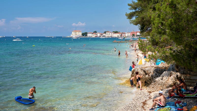 Bathing tourists on the beach of Porec in Croatia