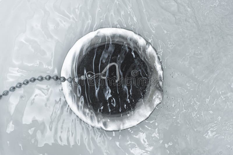 The Bathroom Drain is Covered with a Rubber Plug Under Water Stock
