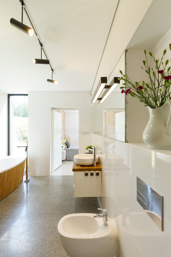 Modern bright bathroom with granite floor and free standing bath with wooden enclosure. Bathtub stand stock images, royalty-free photos and pictures