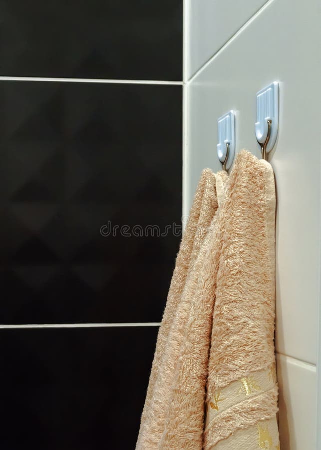 Bathroom Hooks with Hanging Beige Towels for Shower Stock Image