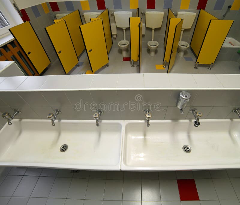 Bathroom of a Nursery School with Small Toilets and Ceramic Sink Stock