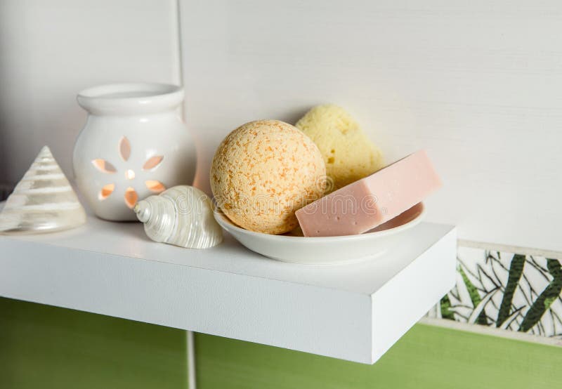 Bathroom products on simple minimal floating shelf indoors in bathroom.