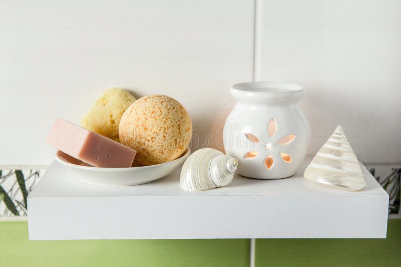 Bathroom products on simple minimal floating shelf indoors in bathroom.