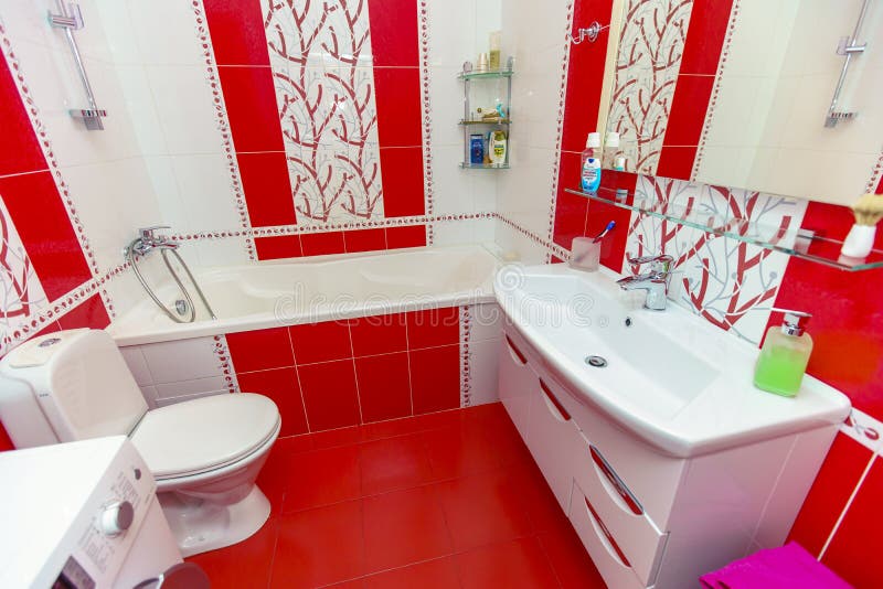 Bathroom in a small apartment. tile with red and white pattern. Toilet, bathroom, sink, mirror stock image Bathroom in a small apartment. tile with red and white pattern. Toilet, bathroom, sink, mirror stock image
