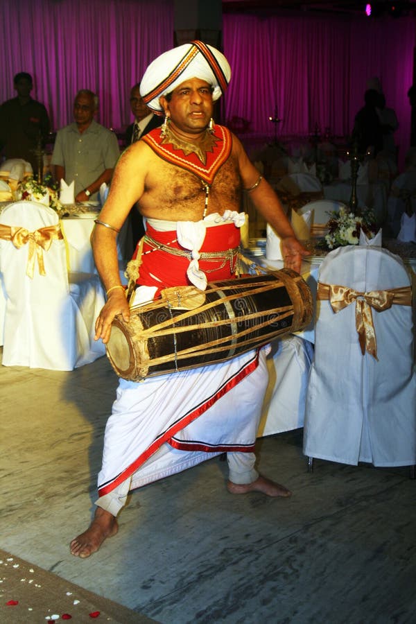 A srilankan drummer with traditional clothes during a wedding in kandy in sri lanka.august 2011. A srilankan drummer with traditional clothes during a wedding in kandy in sri lanka.august 2011