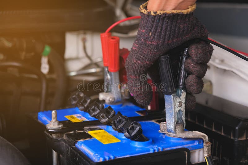 Battery charging cables transferring power , Man calling to car Mechanic service.