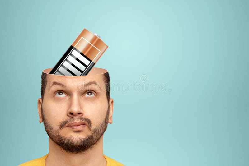 A Battery is Charging in the Man`s Head. the Concept is To Charge the