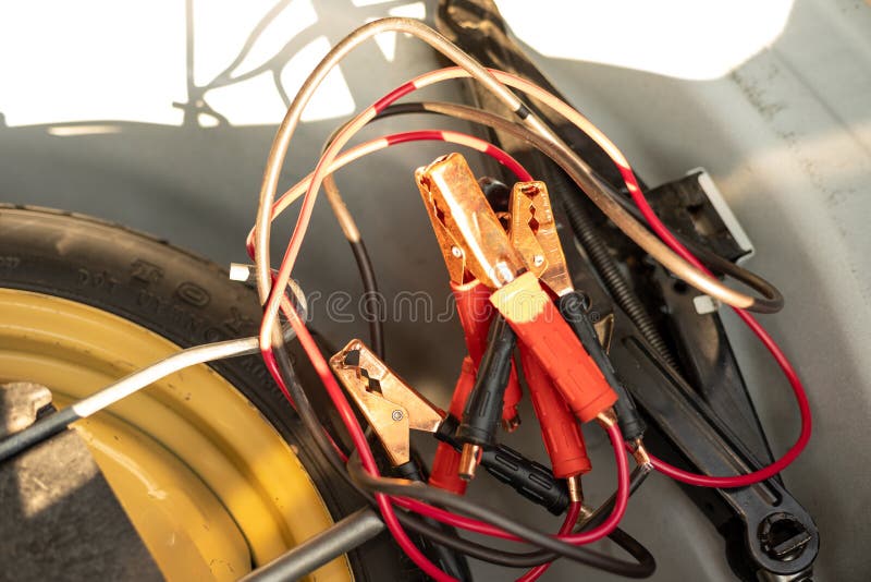 Battery Jumper Cable with Jack and Tools in Car Trunk Stock Image
