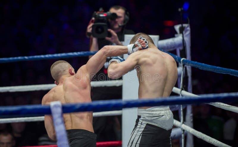 Battle MMA fighters kick hand to head stock image Battle MMA fighters kick hand to head stock image