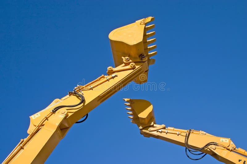 Two back hoe diggers high in sky. Claw machine stock images, royalty-free photos and pictures