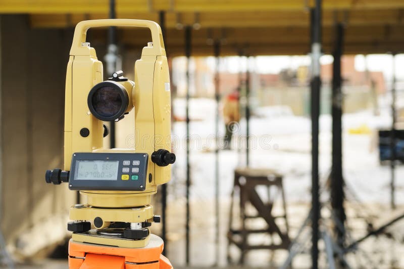 Construction equipment theodolite at building site of modern house. Construction equipment theodolite at building site of modern house