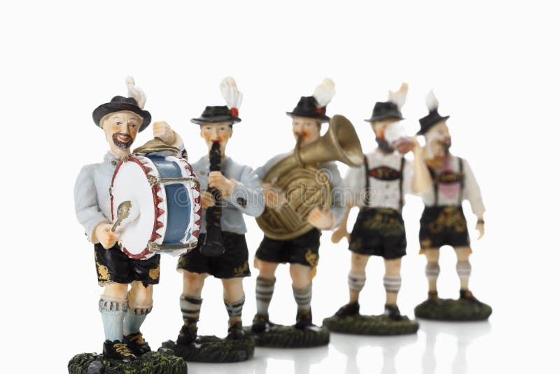 Bavarian figurines playing music on white background