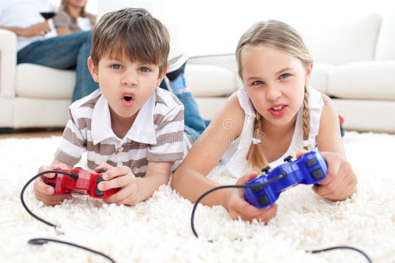 Animated children playing video games lying on the floor. Animated children playing video games lying on the floor