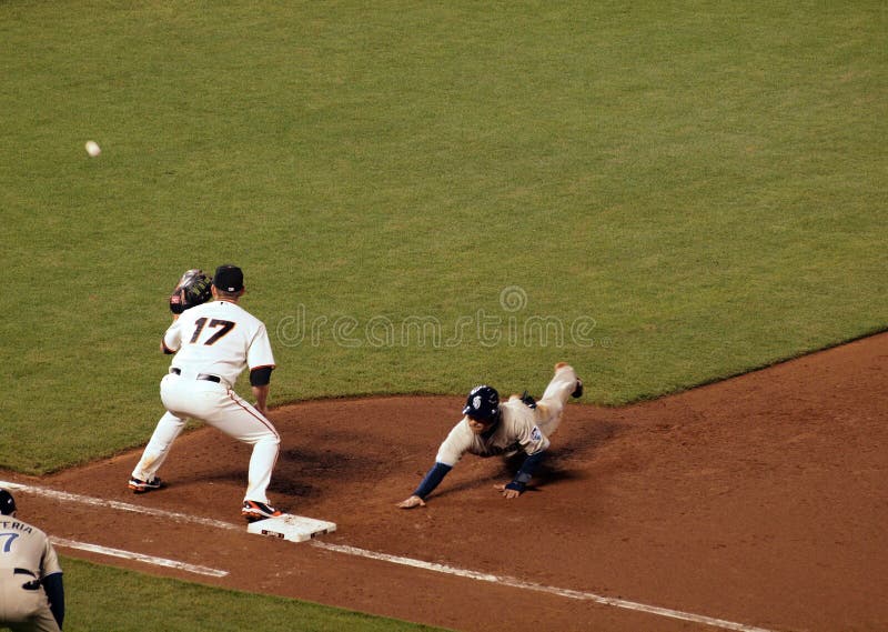 San Francisco Giants vs. San Diego Padres: First baseman Aubrey Huff gets ready to catch a ball thrown from the pitcher as a Padre baserunners slides head first back to first, taken at At&T Park San Francisco on MAy 12, 2010. San Francisco Giants vs. San Diego Padres: First baseman Aubrey Huff gets ready to catch a ball thrown from the pitcher as a Padre baserunners slides head first back to first, taken at At&T Park San Francisco on MAy 12, 2010.