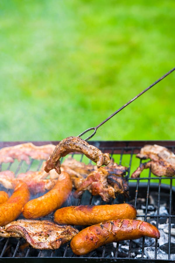 BBQ in the Garden - Selection of Meat on Flaming Grill Stock Image ...