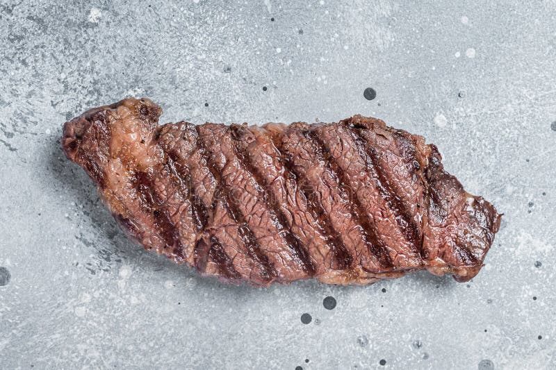 BBQ Grilled Denver Beef Meat Steak on a Table. Gray Background Stock