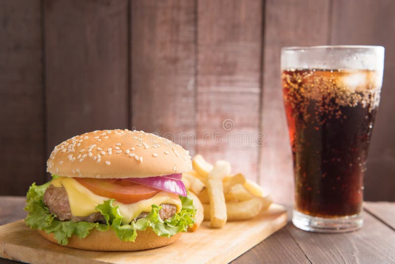 BBQ hamburgers with cola on wooden background. BBQ hamburgers with cola on wooden background