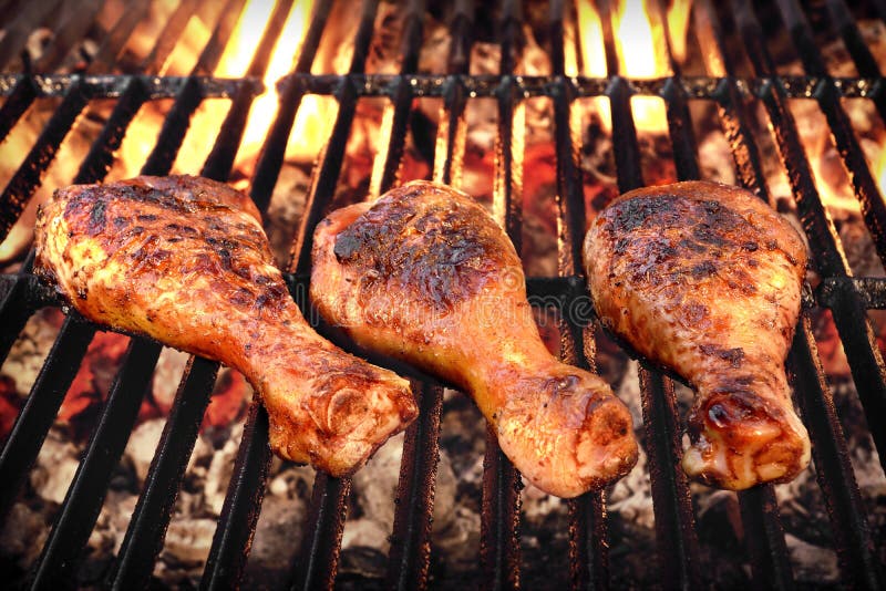 BBQ Chicken Legs Roasted On The Hot Flaming Charcoal Grill, Top View Close Up. BBQ Chicken Legs Roasted On The Hot Flaming Charcoal Grill, Top View Close Up