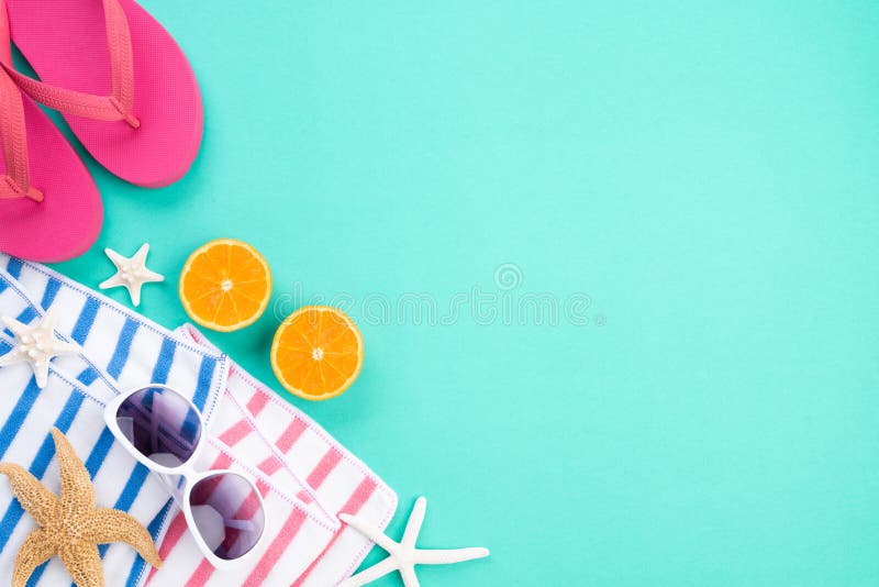 Beach accessories sunglasses, flip flop starfish, a half piece of orange and sea shell on green paper background for summer stock images Beach accessories sunglasses, flip flop starfish, a half piece of orange and sea shell on green paper background for summer stock images