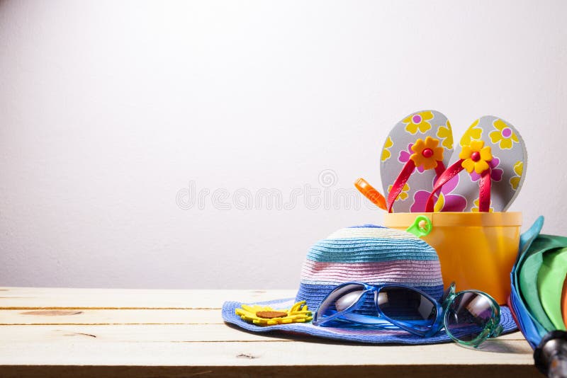 Beach accessory,hat,sunglasses,shoes,umbrella on wooden, concept