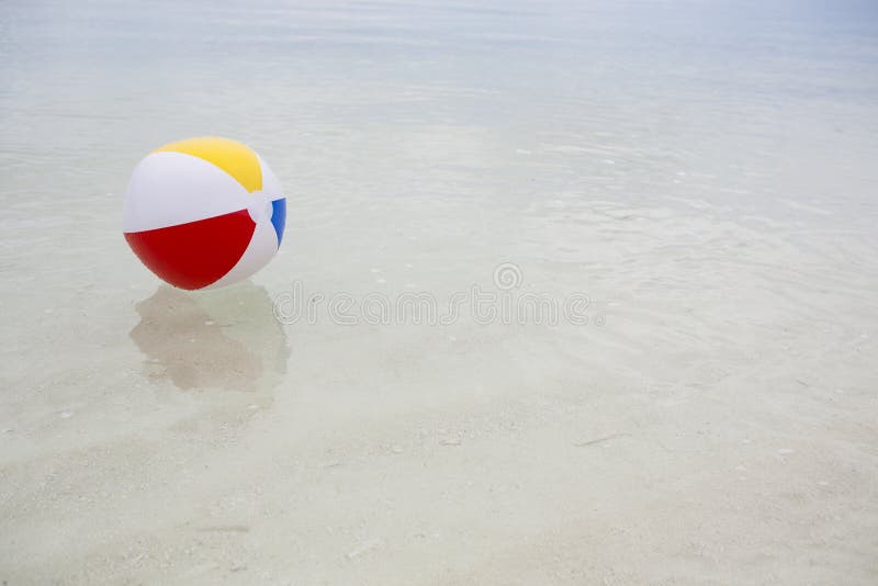 Beach ball in the sea stock photo. Image of coast, outdoor 27338290