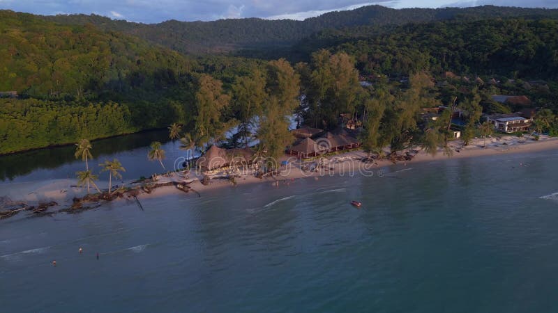 Beach bar party in the evening on spit sunset. Stunning aerial view flight drone