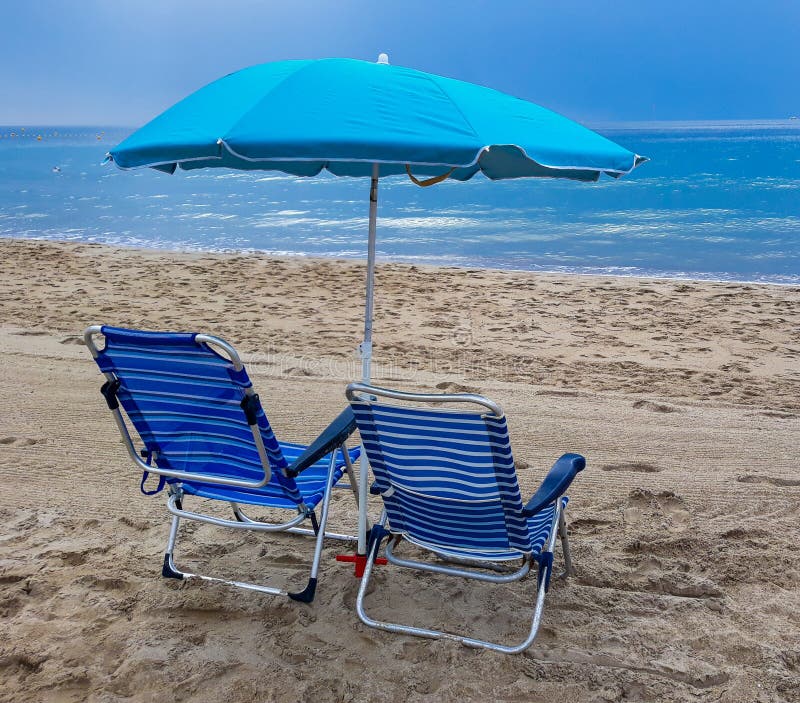 Beach Chairs with Blue Umbrella and Beautiful Beach on a Sunny Day ...