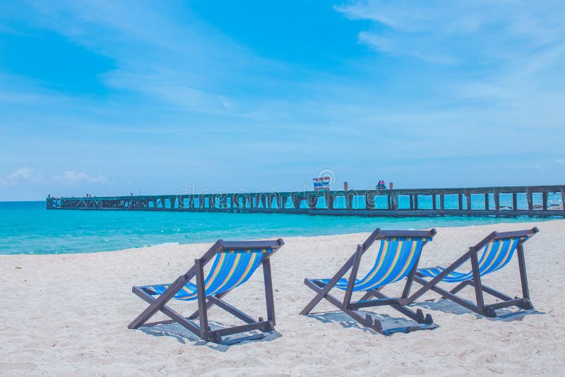 Beach Chairs And Beach Umbrellas Are On The Lawn At The Beach.Sea View