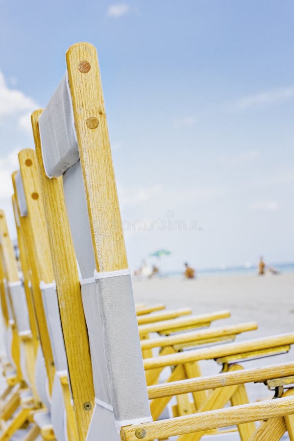 Summer Beach Scene with Palm Trees and Lounge Chairs Stock Image